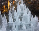 Ice sculpture, a mass of pointy ice turrets catching the light filtering through the trees behind.