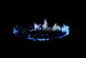 Photoshopped image of one of the crowns of ice that form on my garden table, this is predominently blue and white on a black background and reminds me of a hasty brass rubbing.